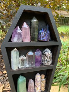 a shelf filled with lots of different colored rocks