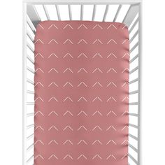 a pink crib sheet with white lines on it