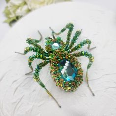 Welcome to my store!   My small store is a world of handmade, unique designs, unusual creations and unique jewelry gifts. My works are unique and created in a single copy. Introducing our stunning large spider brooch.   This handmade Spider brooch  emphasize your personality and make you stand out from the crowd. The Sparkling Spider Brooch is a unique gift for your mom, wife, sister, friend, colleague or a  special person!  This is an unusual and memorable accessory for spider lovers. The embro Unique Handmade Collectible Pins, Handmade Brooches For Halloween Gift, Beaded Christmas Spider, Spider Inspired Jewellery, Green Spider, Big Spiders, Beaded Spider Brooch, Large Spiders, Spider Brooch