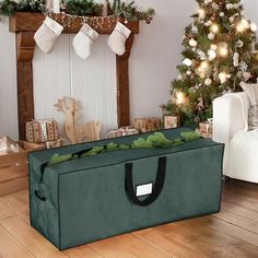 a christmas tree and presents in a living room with a green bag on the floor