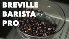 a glass bowl filled with coffee beans on top of a counter