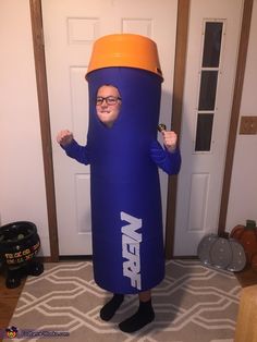 a man dressed as a giant blue tube with an orange top and glasses on his head