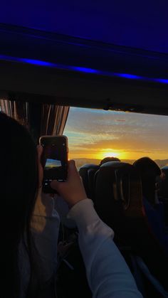 a person taking a photo with their cell phone in the back seat of a vehicle