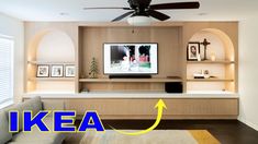 a living room with a ceiling fan and a tv on the wall above it that reads ikea