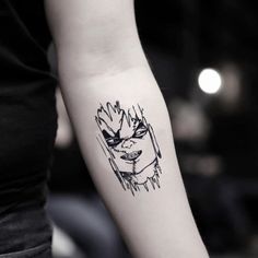 a woman's arm with a tattoo on it that has an image of a face