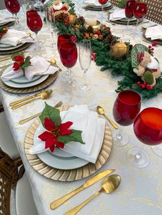 the table is set for christmas dinner with silverware