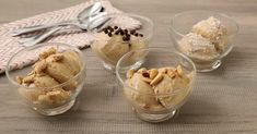 four glass bowls filled with ice cream and nuts