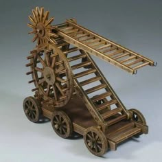 a wooden model of a ferris wheel with wheels on it's sides and a ladder up to the top