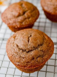 three muffins sitting on top of a cooling rack