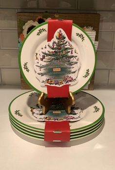 three plates stacked on top of each other in front of a christmas tree plate holder