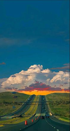 the sun is setting over an empty highway