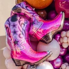 a bunch of balloons that are in the shape of cowboy boots and booties on top of each other