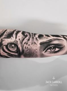 a tiger's eye is shown on the arm and it appears to be in black and white