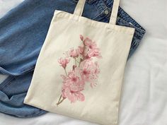 a tote bag with pink flowers on it