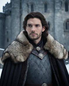 a man with a beard and fur collar standing in front of a castle