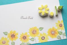 a greeting card with sunflowers on it and two small flowers next to it