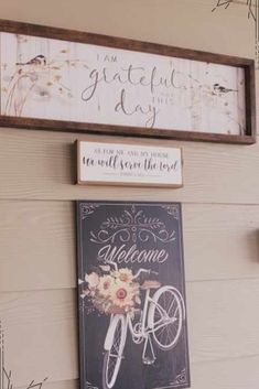 a sign hanging on the side of a wall next to a clock and some flowers