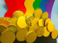 a bunch of cupcake liners sitting in front of a rainbow colored wallpaper