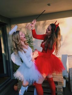 two women dressed in costumes are dancing outside