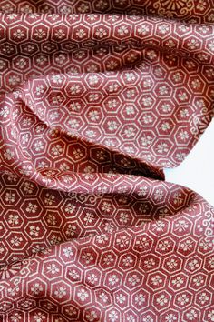 a red and white tie laying on top of a table