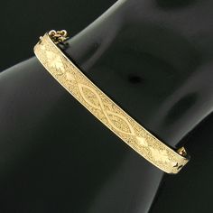 Antique Victorian 14K Yellow Gold 6" Textured Finish Hinged Open Squared Bangle Bracelet Item Details Material: Solid 14k Yellow Gold Weight: 10.52 Grams Size: Will fit up to a 6 inch wrist (inside diameter is 6") Clasp: Box Clasp w/ 3" Curb Link Safety Chain Bangle Width: 6.70mm (0.26") (top of the bracelet - north to south) Thickness: 2.20mm rise off the wrist Condition: Antique, Victorian era bracelet w/ original finish and patina preserved. Excellent condition! Stock Number: EG-19033479-21113006-PAR-EY Additional Info This beautiful antique bangle bracelet was crafted from solid 14k yellow gold during the Victorian era and features a squared edge with a gorgeous textured finish throughout which gives this piece such an outstanding look. The elegant pattern running throughout its center Era Bracelet, Beauty Games, Elegant Pattern, Safety Chain, Box Clasp, Simple Beauty, Gold Texture, Antique Victorian, Victorian Era