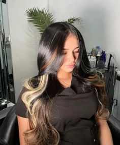 a woman sitting in a chair with long hair