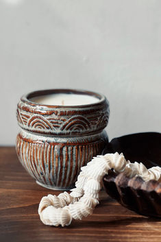 a wooden table topped with a bowl filled with whipped cream