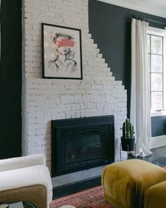 a living room filled with furniture and a fire place in front of a painting on the wall