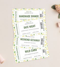 two tickets sitting next to each other on top of a white table with pink flowers