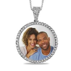 Pull out all the stops with this personalized gemstone photo pendant. Crafted in sterling silver, this charming look features a photo of your choice wrapped in a frame of shimmering white sapphires. All photo pieces are scratch resistant, 100% waterproof, and are available in high resolution color or black and white. Additional sapphires and beaded detailing adorn the bail. Buffed to a brilliant luster, this pendant suspends along an 18.0-inch rope chain that secures with a spring-ring clasp. Pl Customizable White Round Jewelry, Personalized Silver Jewelry With Diamond Accents, Personalized White Gold Jewelry With Diamond Accents, Customizable Silver Jewelry For Keepsakes, Customizable Silver Round Pendant Jewelry, Customized Silver Medallion Jewelry, Customizable White Gold Round Pendant Jewelry, Customizable Round Diamond Jewelry, Personalized Round Pendant Jewelry