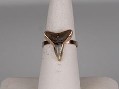 Stunning fossilized shark tooth gold ring.  The ring is set with solid 14k gold, the backplate of the ring is sterling silver (you can't see the silver when wearing) and the band is 14k gold-filled size 7.  This ring is handmade and waterproof. Shark Tooth Ring, Tooth Ring, Jupiter Fl, Shark Tooth, Shark Teeth, Rings Statement, Gold Ring, Statement Rings, Gold Filled