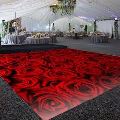 a large red rose carpet is in the middle of a dance floor