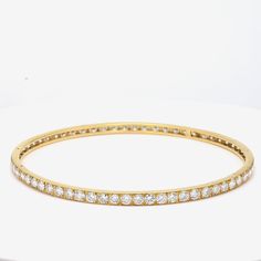 Title: 9.75 Carat Diamond 18 Karat Yellow Gold Bangle Bracelet Style: Bangle Metal: 18 Karat Yellow Gold Gemstone 1: 9.75 Carat Diamond Number of Stones: 65 Color: G Clarity: VS1 Shape: Round Brilliant Dimension: 7-3/4in X 3.5mm Weight: 11.8 Grams Condition: Vintage And Estate Product ID: R21J58 Note: Please note that all the non-GIA Gemstones' Weight, Color, Cut, and Clarity are estimated values to the best of our knowledge. Luxury Oval Bangle For Formal Occasions, Luxury Oval Bangle For Anniversary, Luxury White Gold Bracelet Channel Set, Luxury White Gold Bracelets Channel Set, Luxury White Gold Channel Set Bracelets, Luxury Channel Set Diamond Bangle Bracelet, Formal Single Cut Diamond Bangle, Luxury Diamond Channel Set Bangle, Formal Round Brilliant Cut Bangle