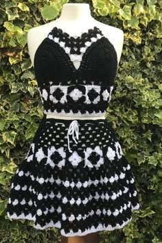 a black and white crochet dress on a mannequin headdress