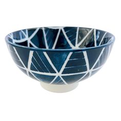 a blue and white bowl sitting on top of a table