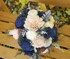 a bridal bouquet sitting on top of a wooden bench