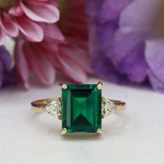 This handmade emerald ring is a true work of art, featuring a stunning octagon cut emerald gemstone that is beautifully complemented by two trillion-shaped moissanites (or simulated diamonds, depending on the metal). The emerald's deep green hue is breathtaking, and its octagon cut adds a unique and eye-catching dimension to the ring. The moissanites (or simulated diamonds) set on either side of the emerald add just the right amount of sparkle, creating a truly mesmerizing piece of jewelry. Insp Ring Rectangle, Rectangle Ring, Green Ring, Green Rings, May Birthstone, Knot Ring, Wire Wrapped Rings, Emerald Engagement Ring, Onyx Ring