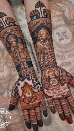 two hands with henna designs on them