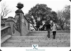 black and white photograph of two people walking up some stairs