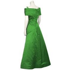 For Sale on 1stDibs - Dramatic 1980's emerald green satin gown by Arnold Scaasi. The dress has a pleated off the shoulder detail that wraps around the front bust. The asymmetrical Green Satin Gown With Pleated Bodice, Green Evening Dress With Pleated Bodice, Green Off-shoulder Evening Gown, Green Off-shoulder Gown For Evening, Green Silk Evening Dress With Pleated Bodice, Green Satin Evening Gown, Green Satin Gown For Gala, Green Off-shoulder Formal Gown, Green Silk Evening Gown