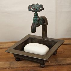 a soap dispenser sitting on top of a wooden table