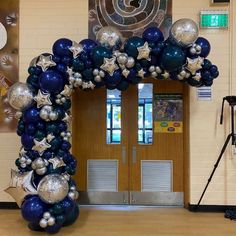 an entrance decorated with blue and silver balloons