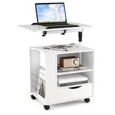 a laptop computer sitting on top of a white shelf next to a bookcase with drawers