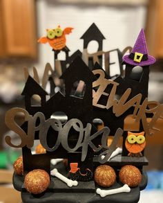 a halloween decoration with pumpkins, bones and witches on it's display stand