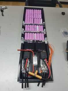 an assortment of batteries and wires in a case