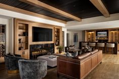 a living room filled with furniture and a flat screen tv on top of a wooden floor