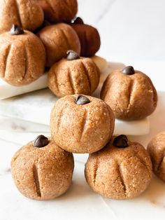 several pumpkin shaped cookies sitting on top of each other with chocolate chips in the middle