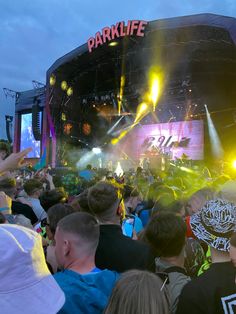 a large group of people standing in front of a stage