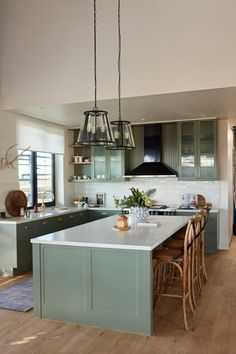 a kitchen with wooden floors and green cabinets