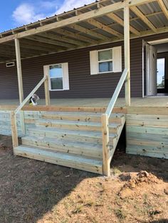 a dog is sitting on the steps outside of a house that's being built